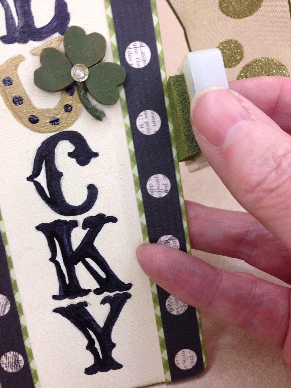 Layer and glue a sequin and rhinestone where the hearts meet. Rub the ink pad along the unfinished edges of the door hanger.