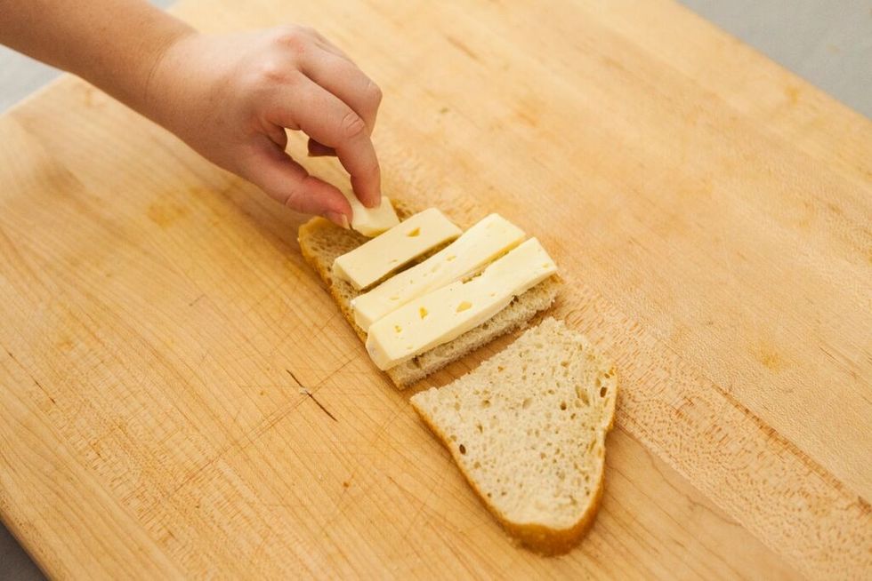 Layer brie on half a piece of your sandwich bread. If you're making two sandwiches, layer brie on each side.