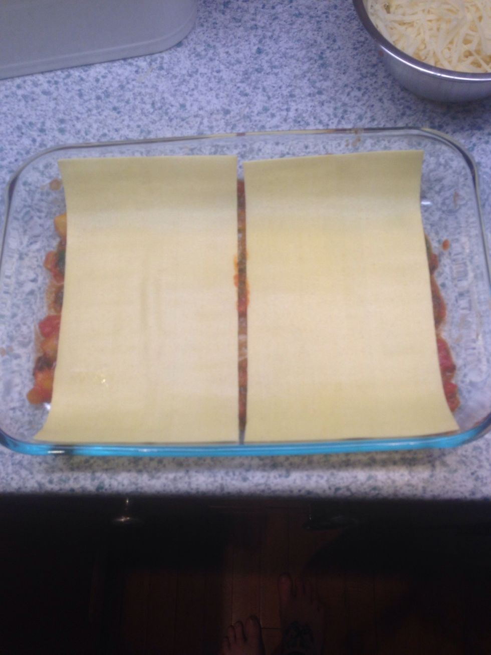 Layer lasagna sheets on top of sauce mixture.
