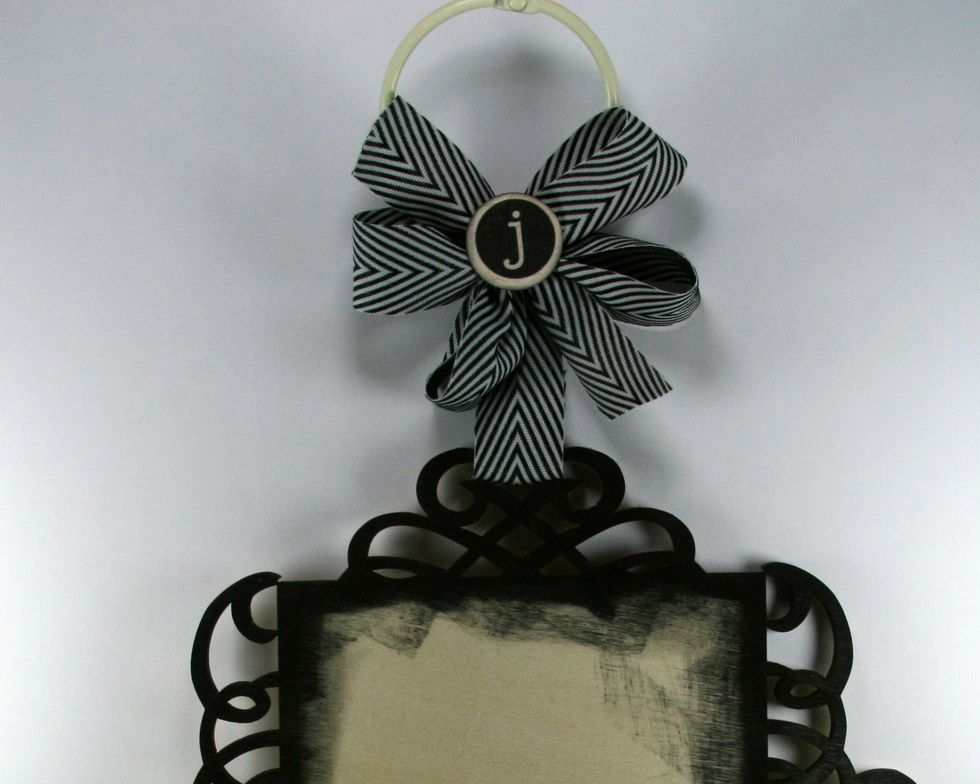 Layer on a poofy bow tied with the chevron ribbon and top with letter die cut or large button.