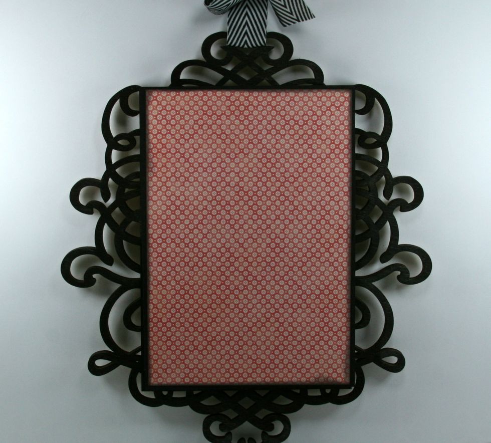 Layer on patterned paper cut 1/8 of an inch smaller. Ink the edges well and secure in the center of the black cardstock.