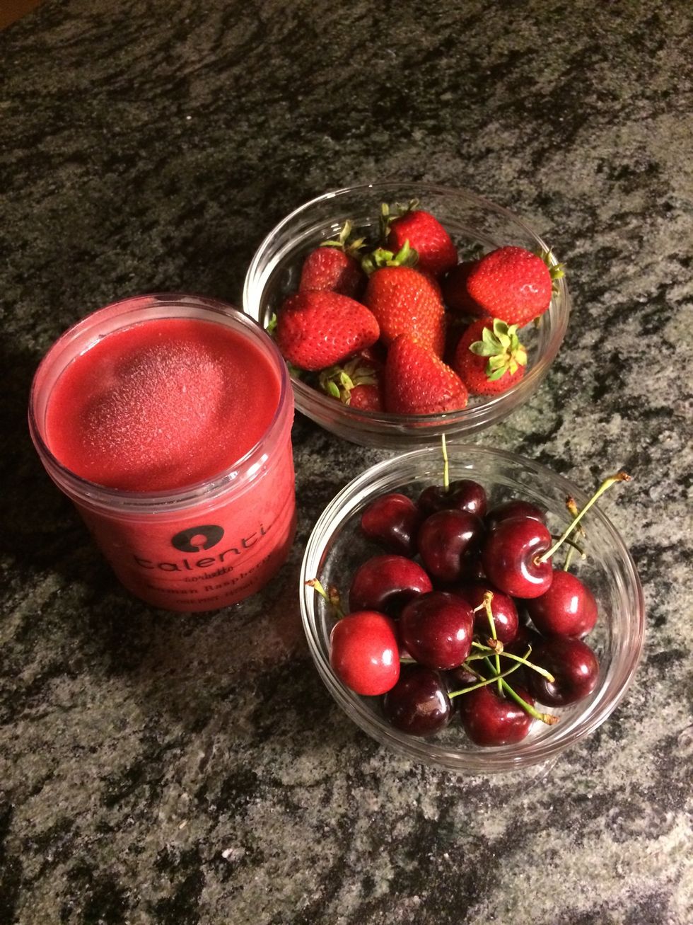 Layer one: Slice a cup of strawberries and halve and pit a cup of cherries.