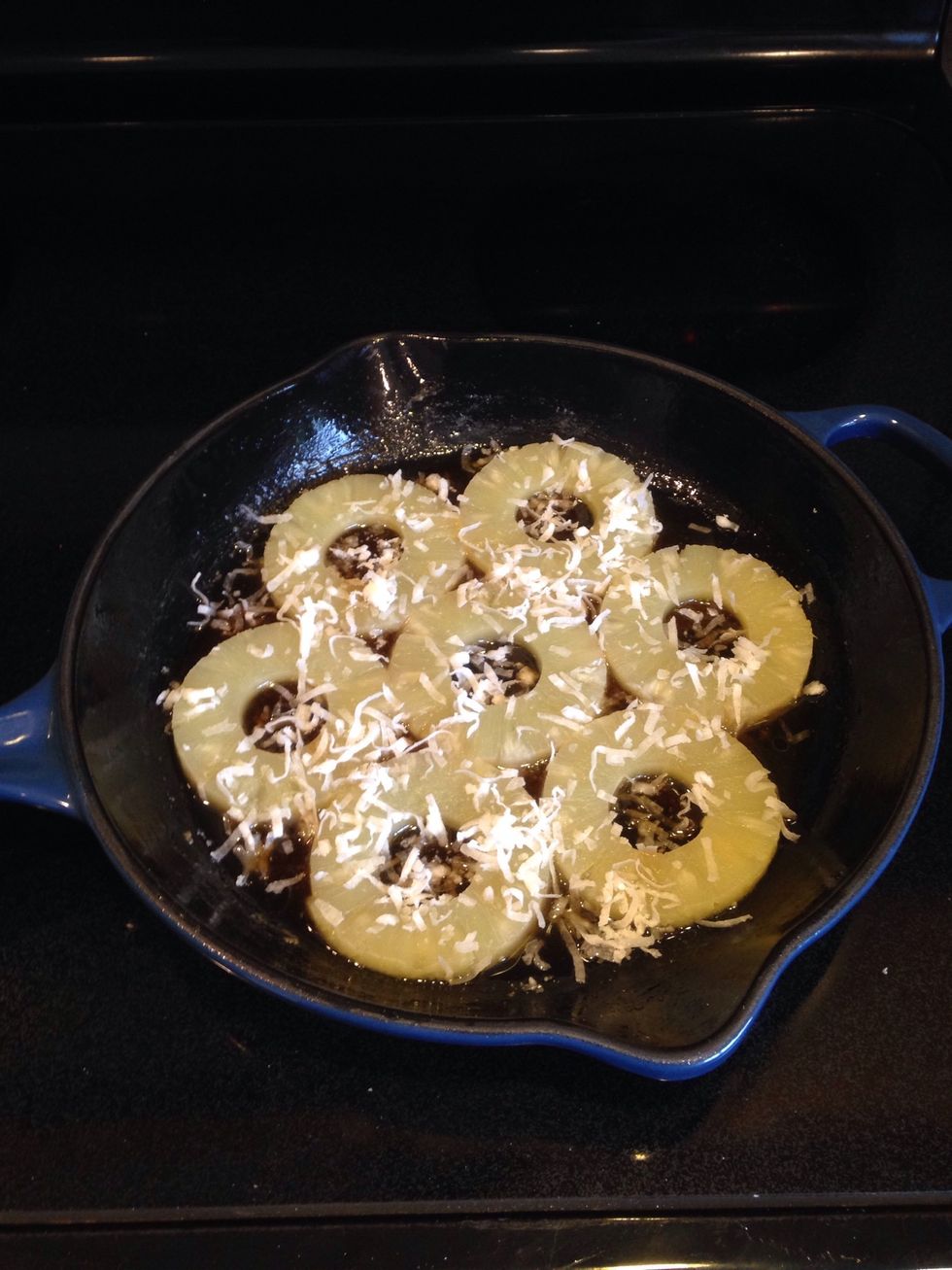 Layer pineapple slices. *If you like cherries, add those to the center of each slice. If so inclined, sprinkle a bit more coconut flakes.
