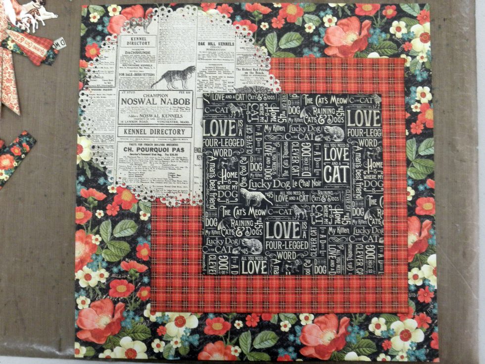 Layer plaid 8.5" square 2" from the top & 1" from the right. Add punched circle to upper left side as shown. Add a 6x6" square from the Patterns & Solids 3.125" from the top & 1.75" from the right.