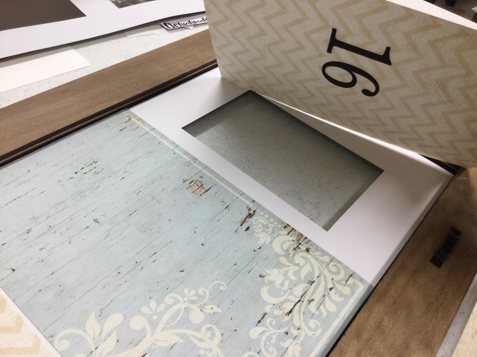 Layer the numbered papers back into the frame. Be sure to check that your pieces are in the right order and facing the correct direction before replacing the frame back.