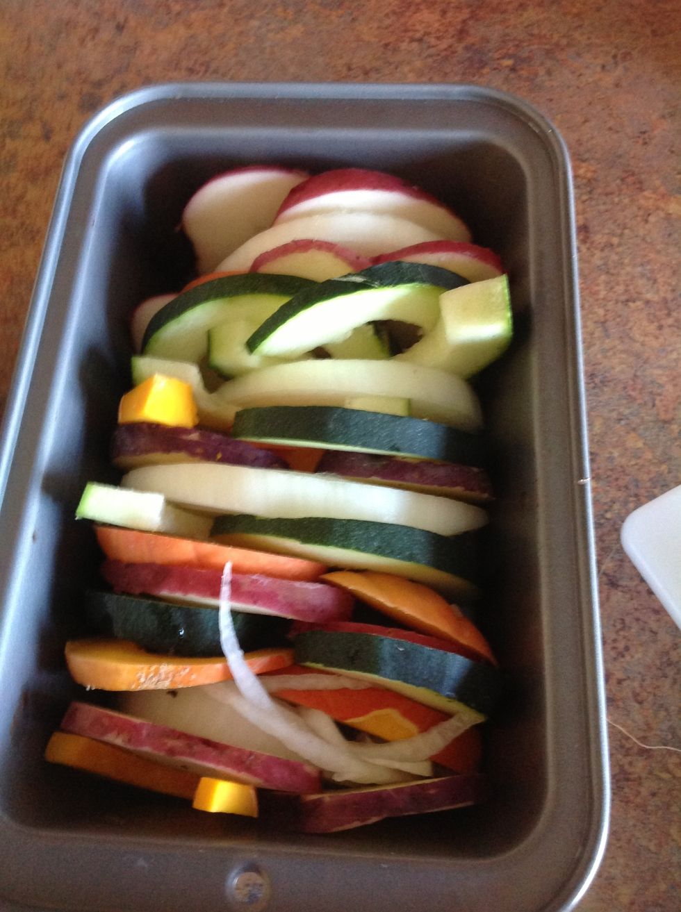 Layer the vegetables in a casserole dish. Make sure to alternate the vegetables.