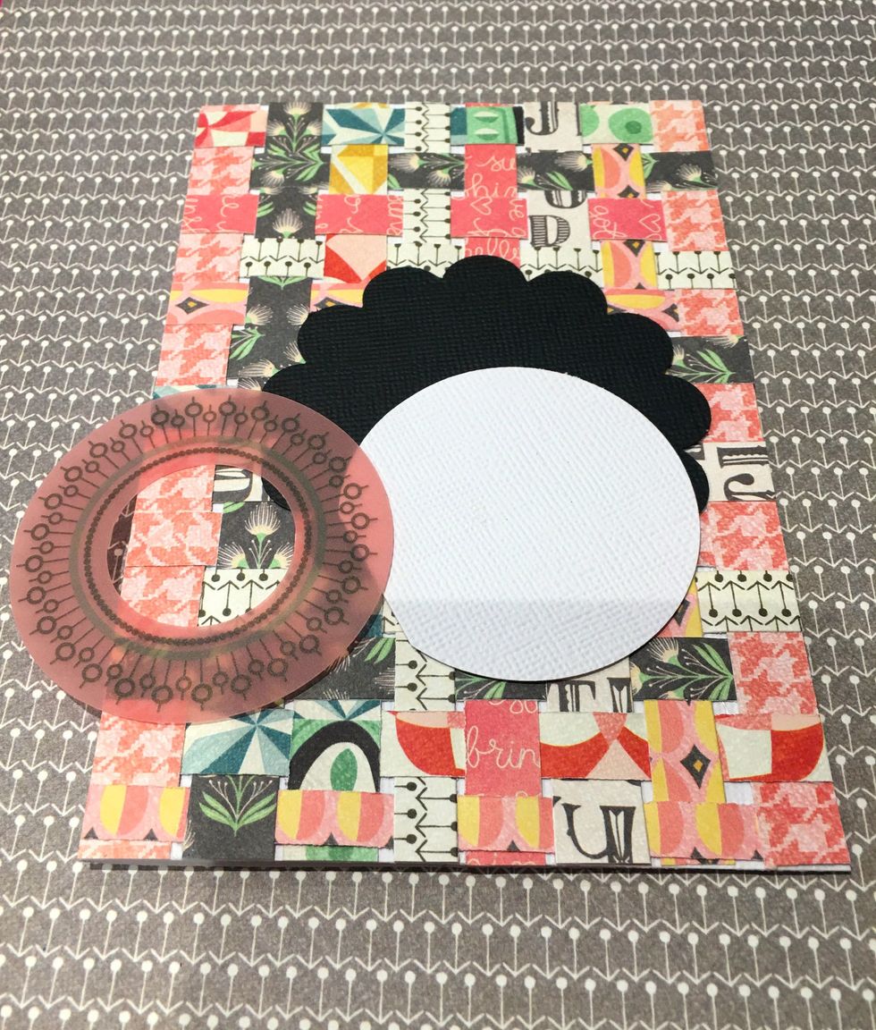 Layer the white circle on top of the black scallop. Place the pink vellum die cut on top of the white card stock.