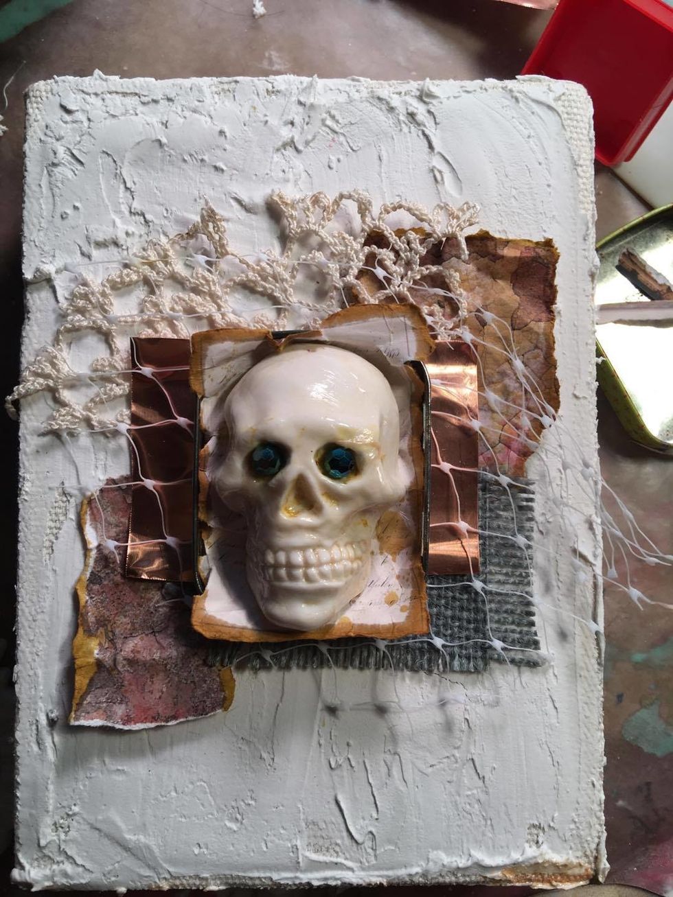 Layer torn Canvas Corp papers and green burlap, vintage crochet, copper sheet and RA Skull for placement. (We will attach these at the end)