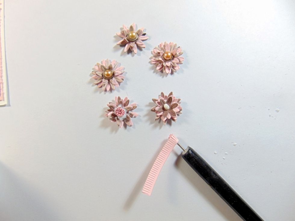 Layer up the different colour paper flower layers. I did 3 small and 3 large layers to a flower. I did 3 flowers put together with brads and 2 made with a stamens die. Mould shape whilst assembling.