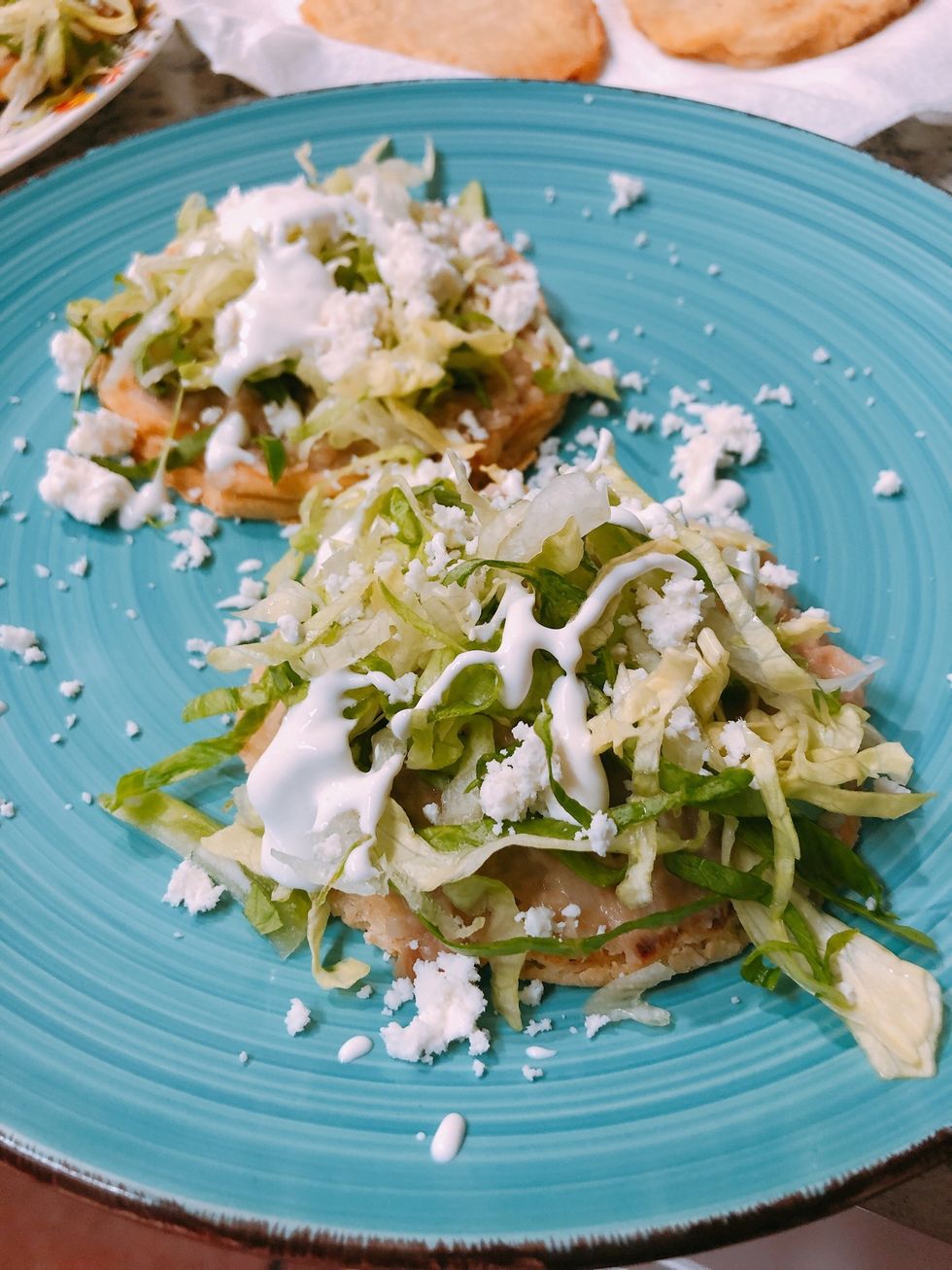 Layer with what you desire.   Pictured:  Refried beans, lettuce, sour cream and cheese