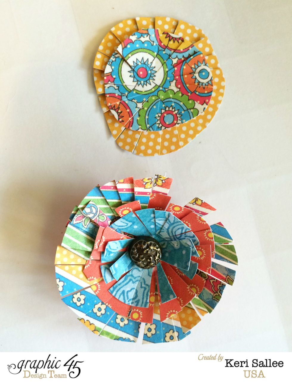 Layer your circles with 2-3 layers and glue them together. Once they are dry, add a Graphic 45 Stamped Brad to the center of a few. {TIP: Use a craft knife to to make your hole for your brad.}