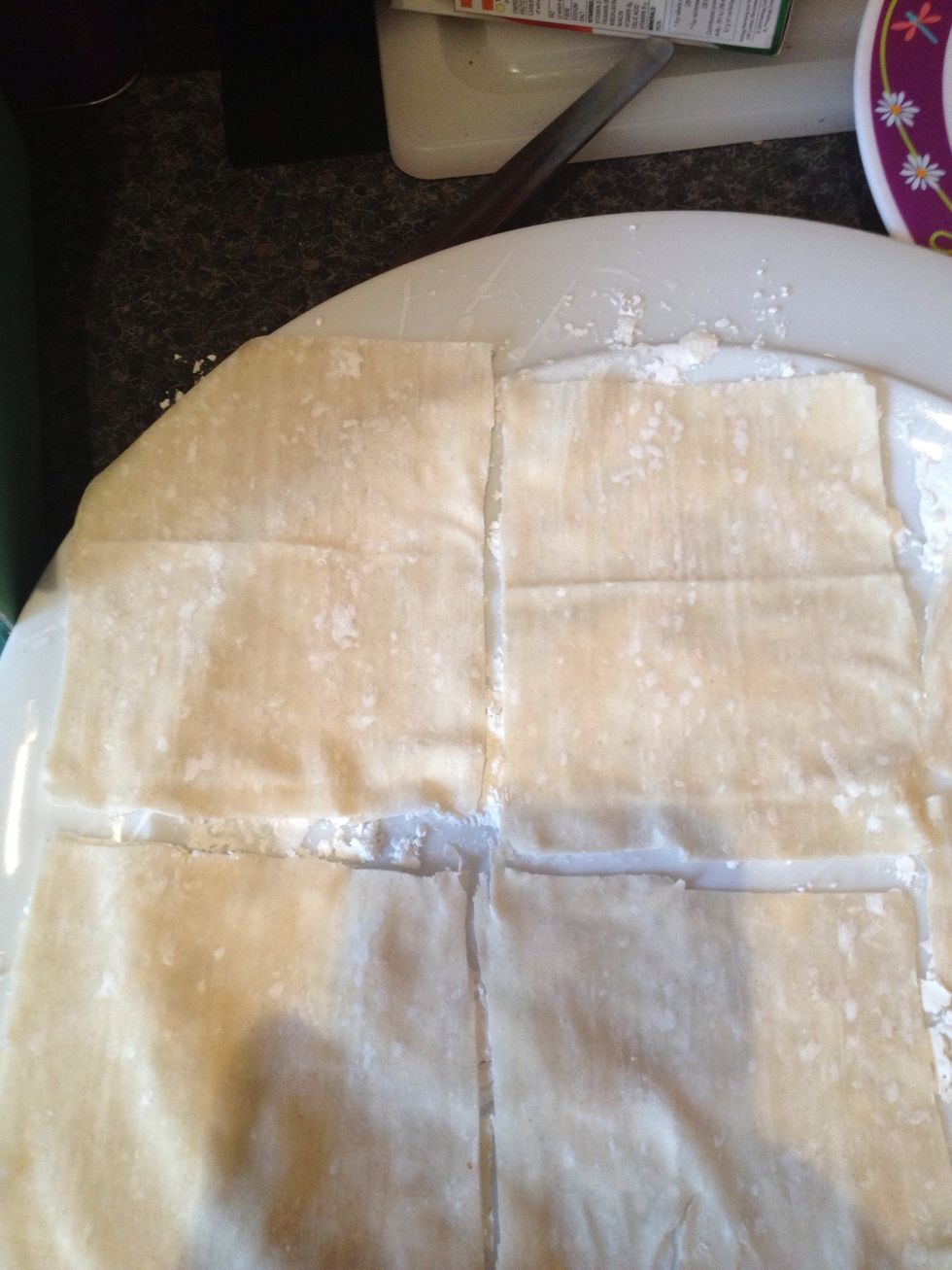 Layout a filo pastry sheet on a surface lightly dusted with corn flour. Then lightly dust the top of the sheet and cut into 4 to 6 squares depending on size of sheet.
