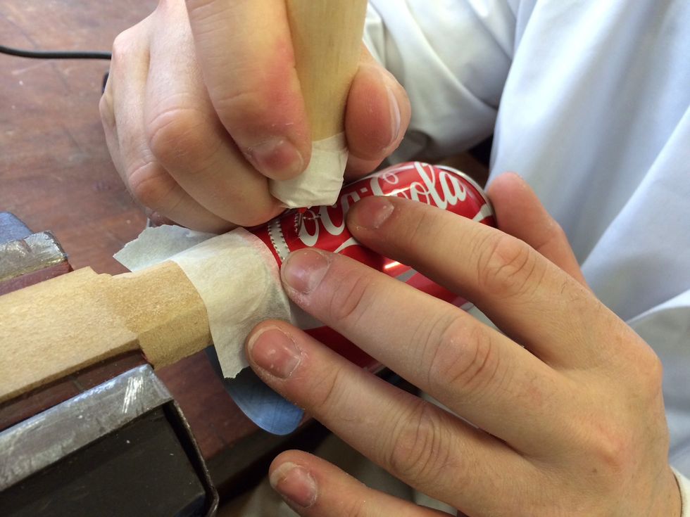 Leaning the can on the scrap MDF, pierce the can along the lines if the logo (or wherever you want!)