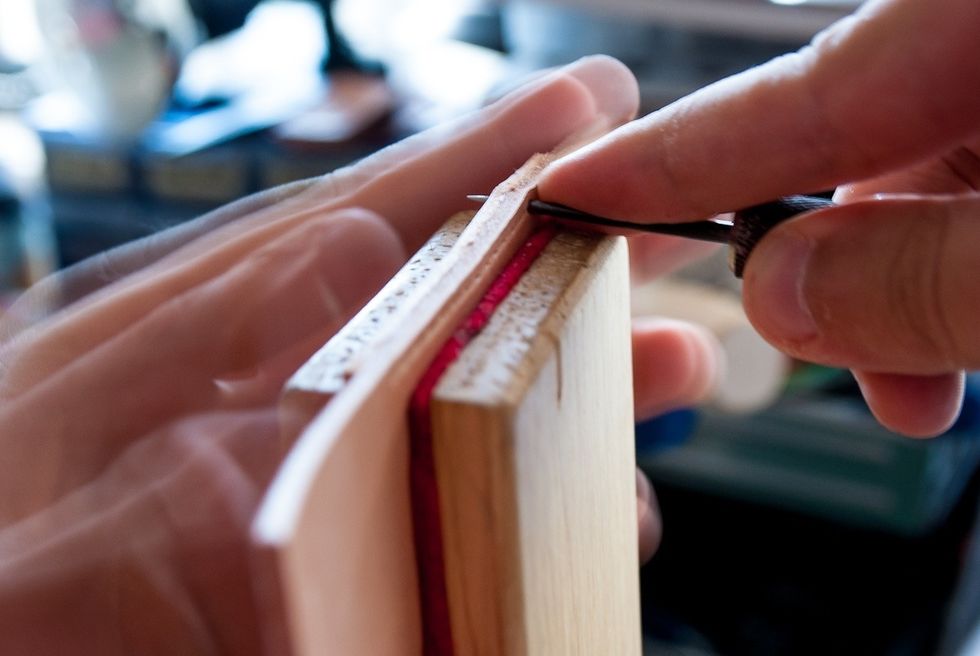 Leather is thick and you'll have to use an awl to pierce it. Always pierce the leather as straight as possible to achieve even stitches. Use left hand to support the leather on the other side.