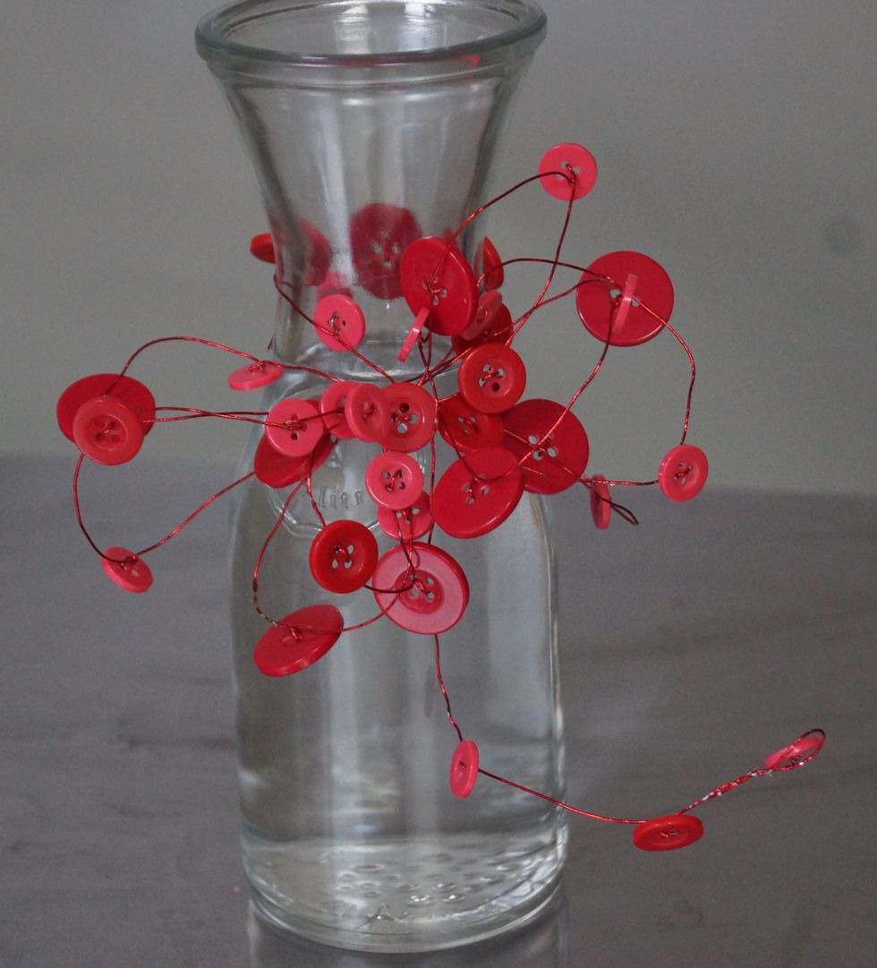 Leave 12" of length at the end of the bow and wrap around the neck of the vase. Twist to secure.