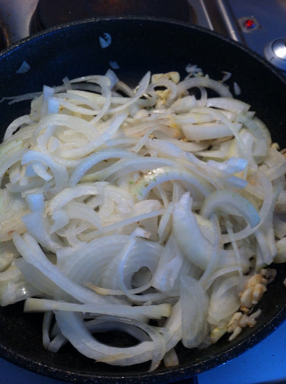 Leave beef in the casserole pot, add onion and garlic, and a table spoon of plain flour, stir fry on medium heat until soft. Turn the heater on and preheat to 180 degrees.