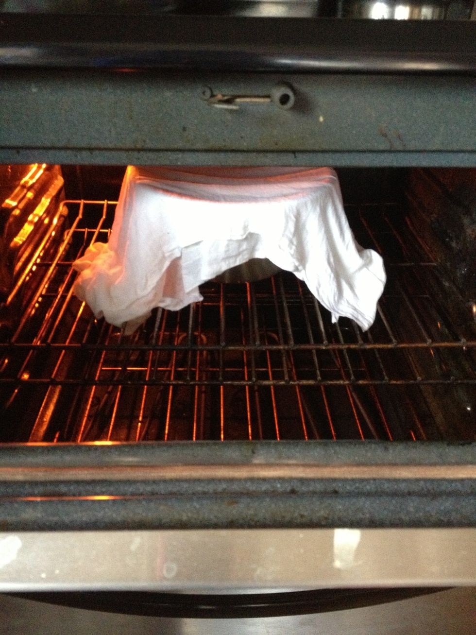 Leave it inside a preheated oven with the door slightly open. In other words, its better to leave it on a warm place. The oven is not on. It can be left on a countertop.