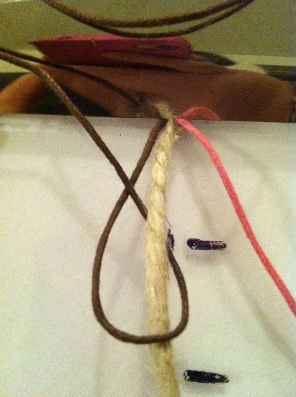 Leave out you second color, this is your wrapping cord. Make a forward knot (fk) over only the center cord.