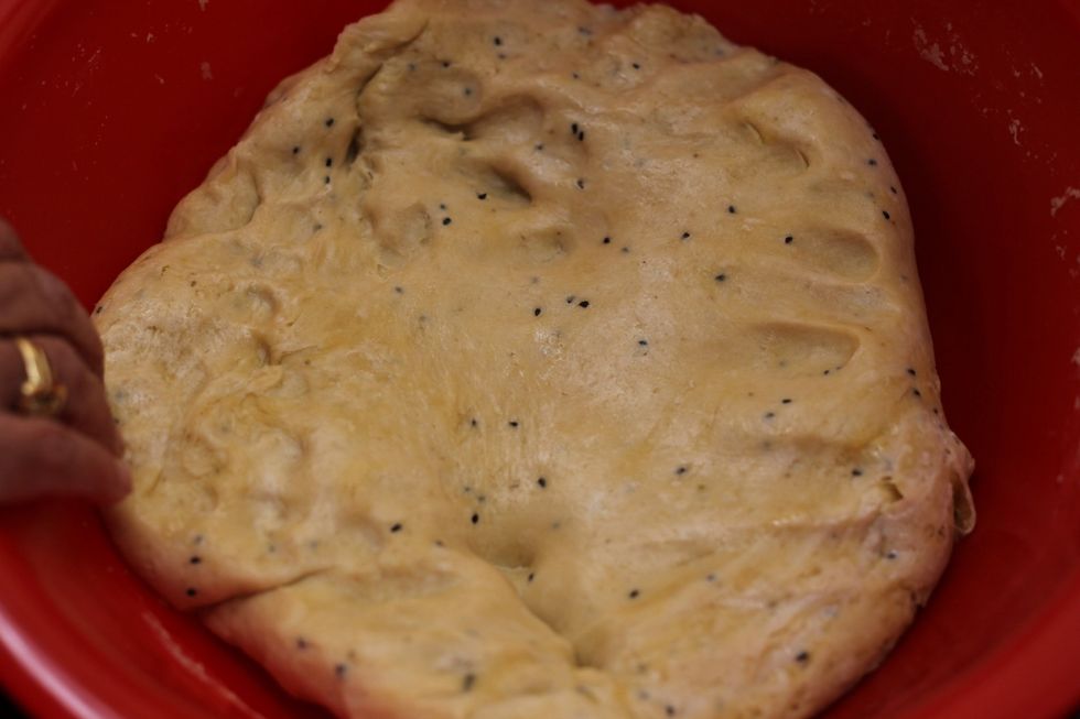 Leave the dough somewhere warm for half an hour or so. Sing it a lullaby if you feel it will speed up the rising process. I tried it, didn't work. Singing optional.