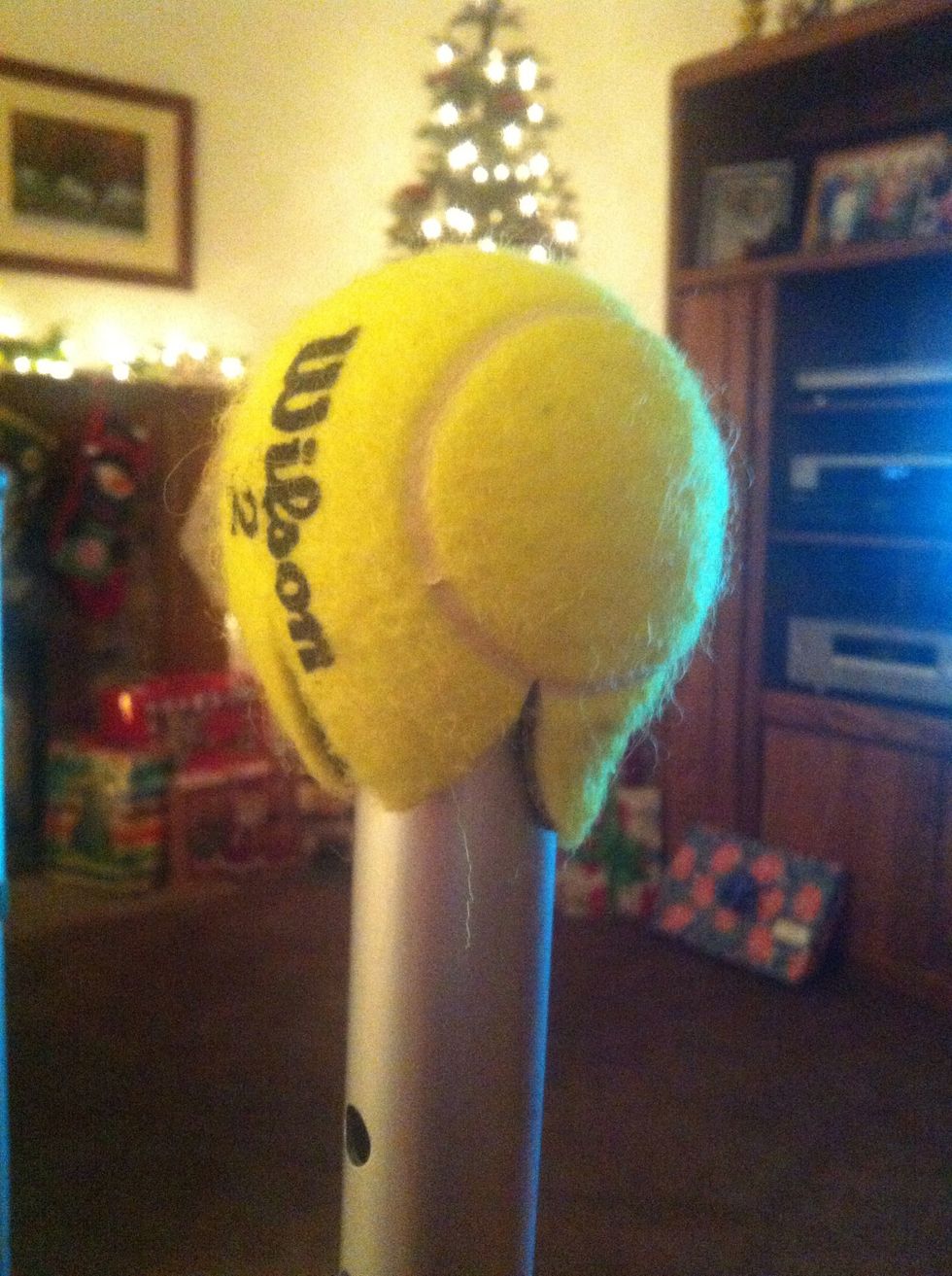 Leave the manufacturer rubber stoppers and pull the tennis ball over the leg.