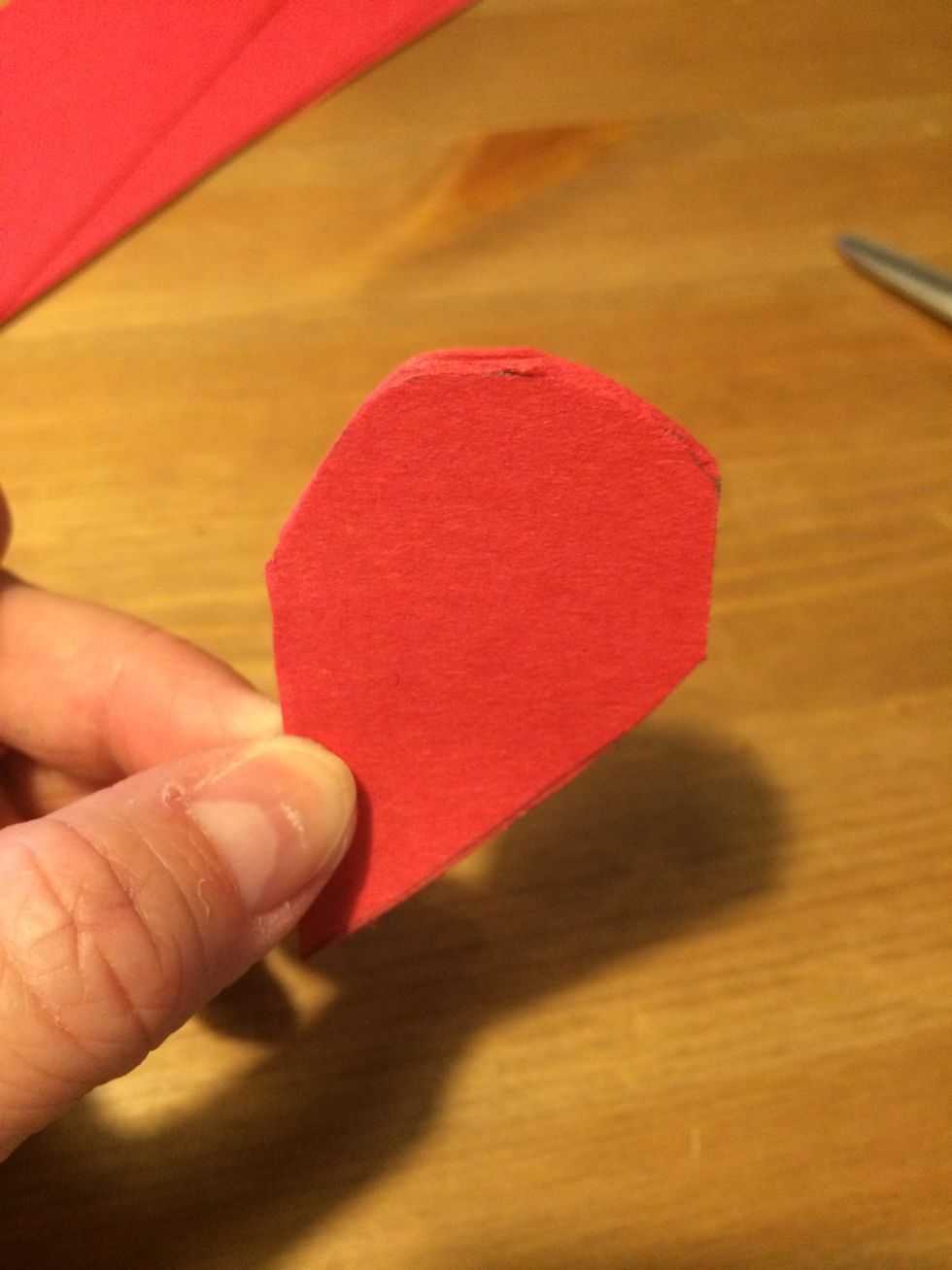 Leaving about a cm uncut on the right edge, cut off the top of the heart.