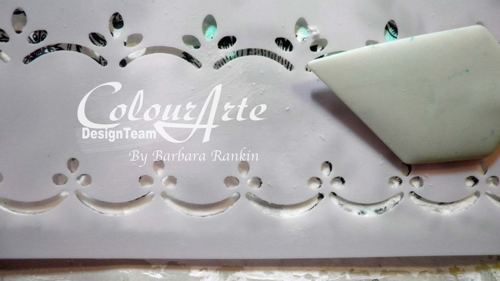 Left page: Spread light modeling paste through eyelet border stencil along the left side and the bottom edges. Allow to dry.