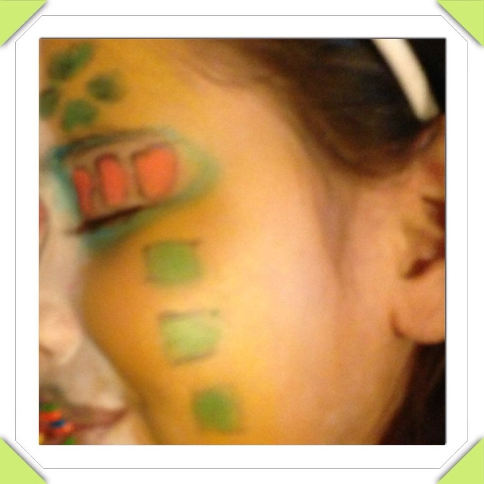 Left side is orange with the green candy crush on the cheeks and orange on her eye lid
