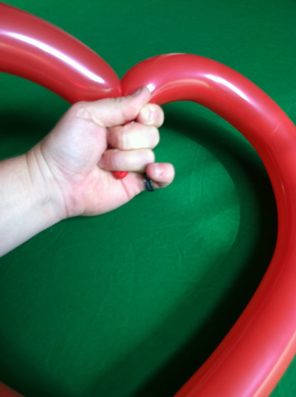 Let all the air out of the center and then slowly let it back in.  This will shape the balloon