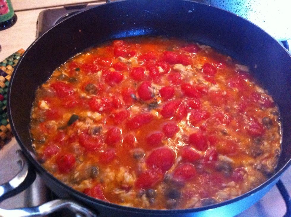Let cook for about 20 minutes, occasionally stirring and adding warm water everytime it thickens too much. Mash tomatoes where they're tender to make them release their juice.