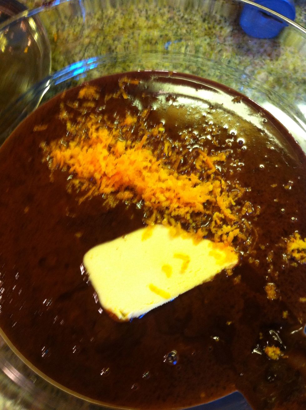 Let cool a few minutes and then add the orange extract, zest, and butter. Pour into bowl and let cool for 30 mins before serving.