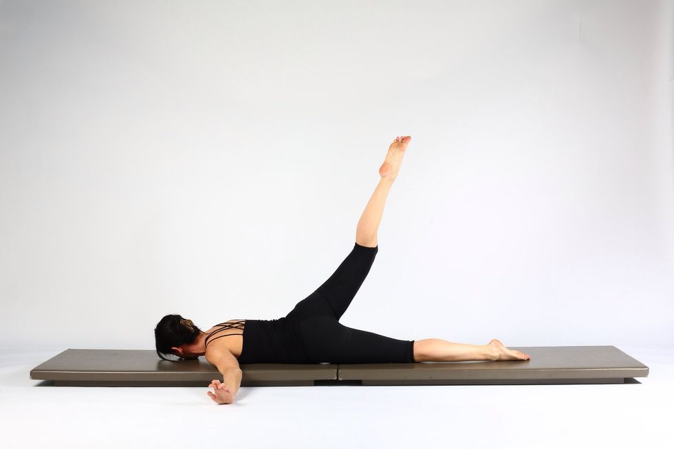 Let go of foot and extend knee reaching right leg up to cieling.