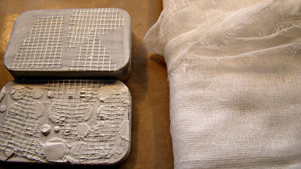 Let's add a bit more texture by cutting some cheese cloth and smoosh it onto the wet texture paste.