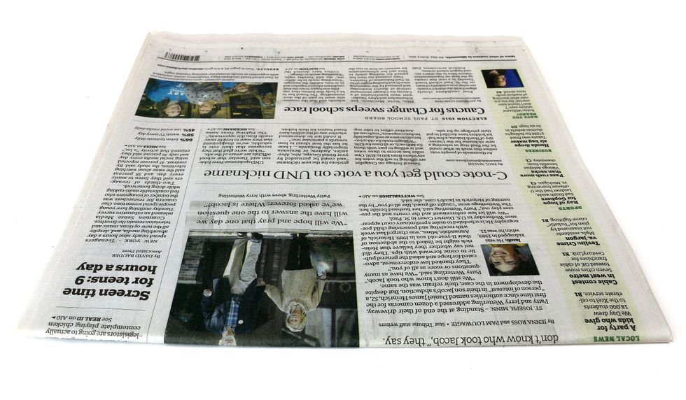 Let's begin by making a person. Grab a section of newspaper to start.