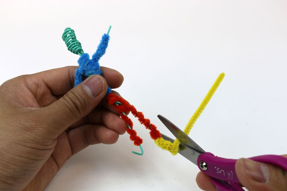 Let's give it a pair of yellow shoes. Wrap the yellow pipe cleaner around each foot.