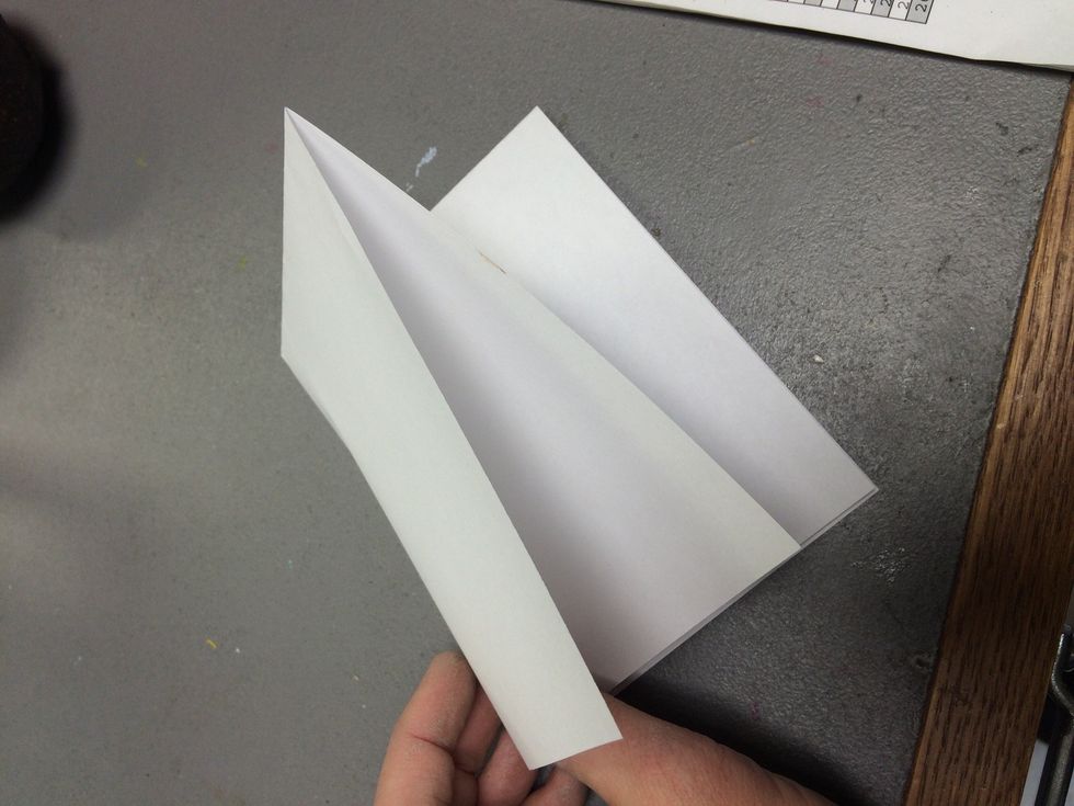 Let's make the template for the loom shape. Fold your paper into quarters.