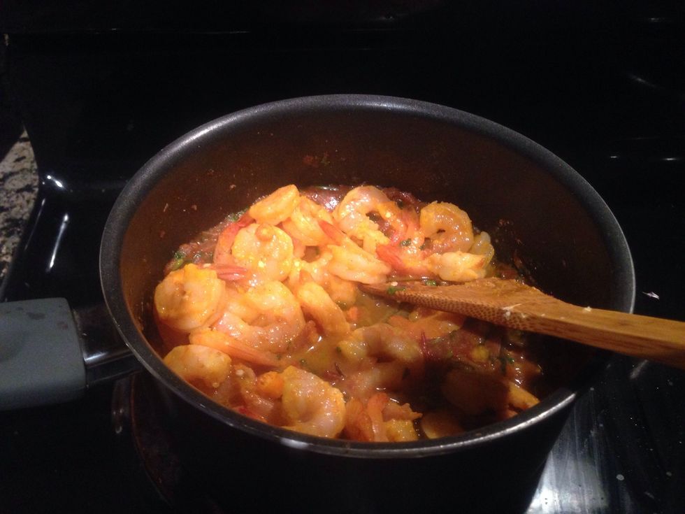 Let's mix the marinated shrimps and sprinkle 1-2 teaspoon of Garam Masala. Also will add some freshly chopped cilantro. Cook it further for 2-3 mins and add some water to keep the consistency.