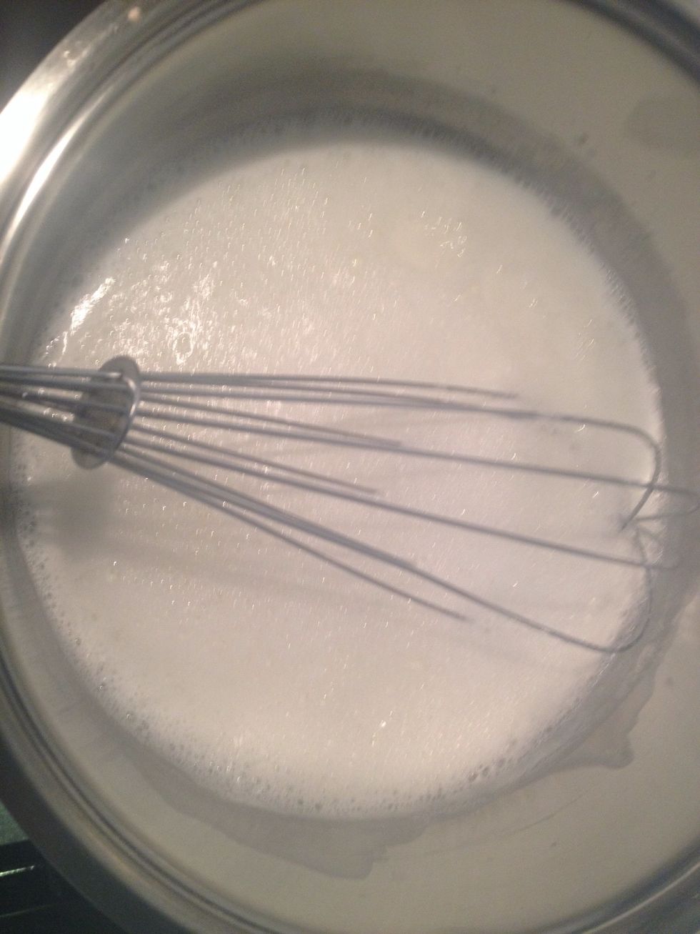 Let's prepare the milk cream! Add some milk to the sugar and let the mixture boil