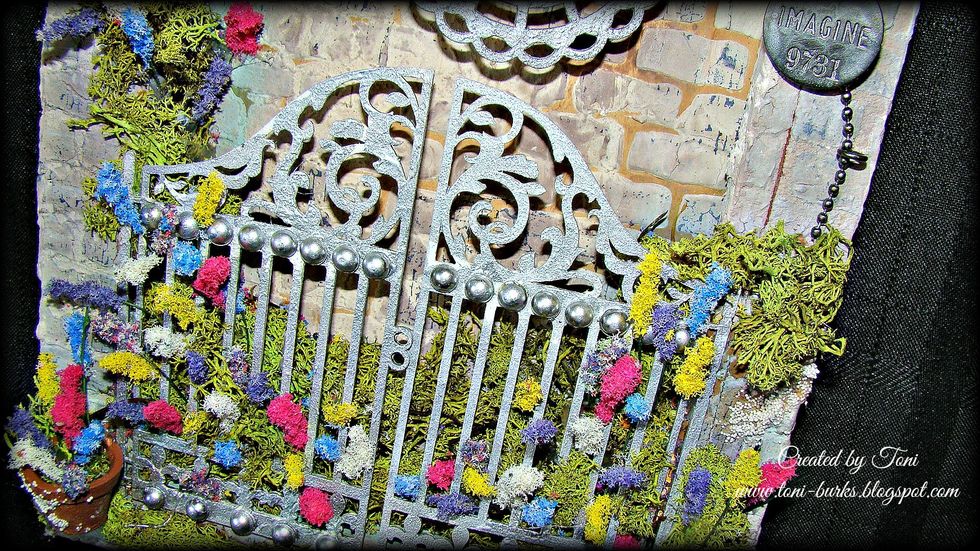 Let's start adding our stems here and there. Also add some moss to the high sides of the canvas for eye appeal and interest. Add your flowers inside the moss also.