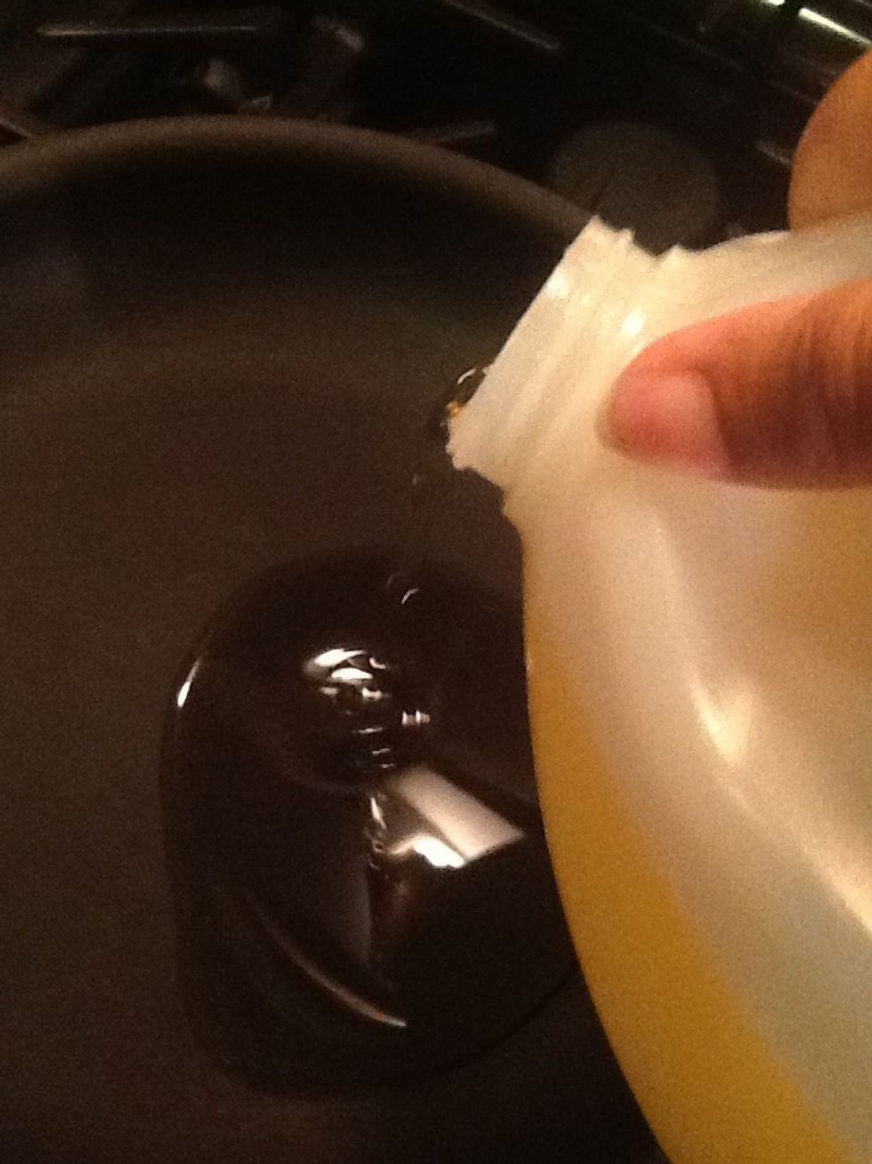 Let's start frying the steaks. Take some oil and put it in a pan set over medium high heat.