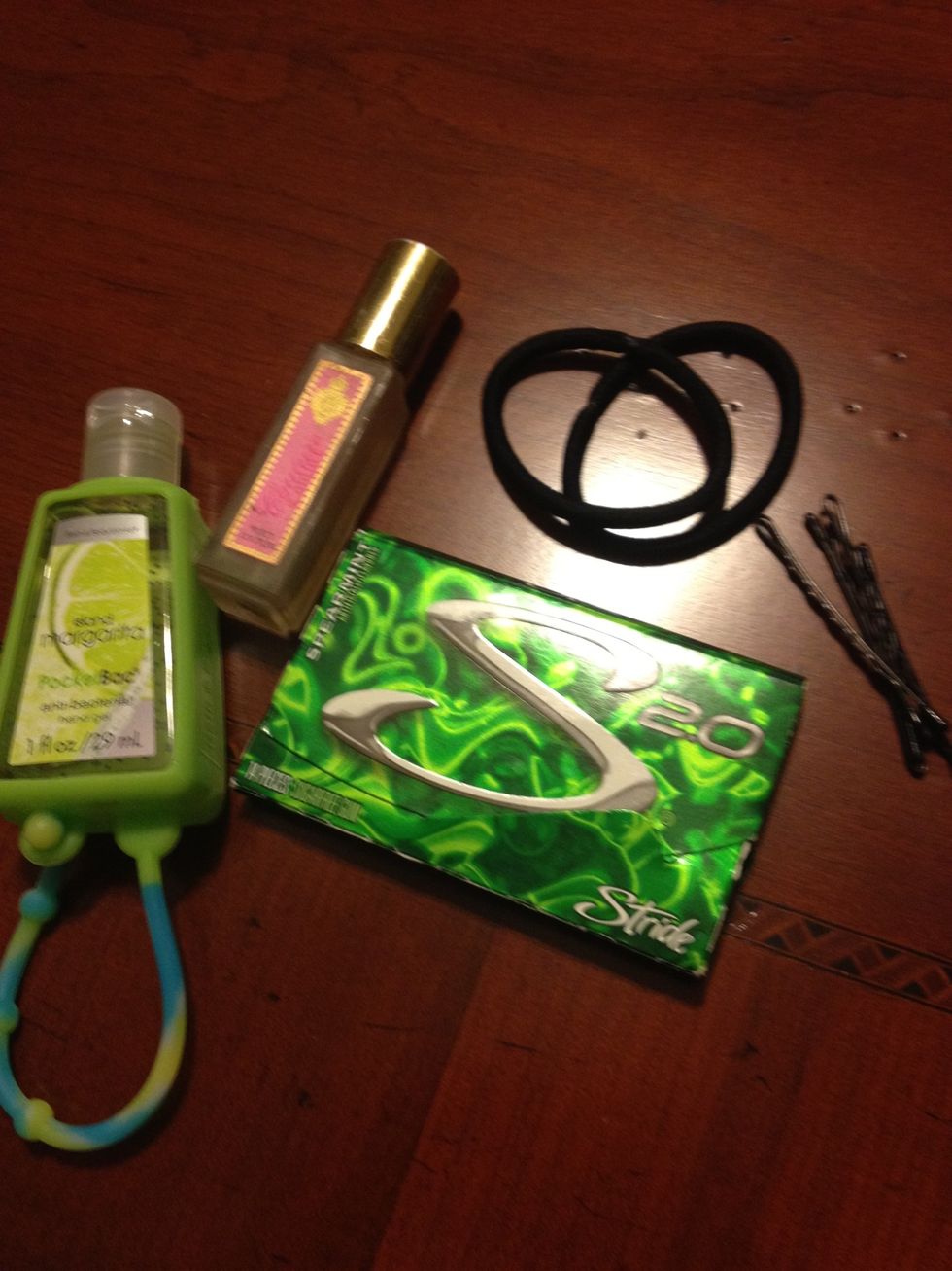 Let's start with the non-makeup items first. It's a good idea to keep hairbands and bobby pins with you! I like to keep gum, hand sanitizer, and eau de parfum with me to stay fresh throughout the day.