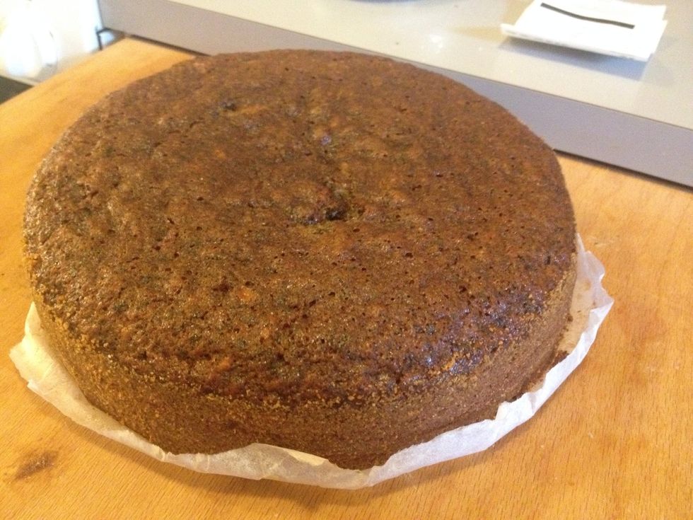 Let the cake cool; if you're in a hurry place it in the freezer for a while, to prepare it for the frosting.