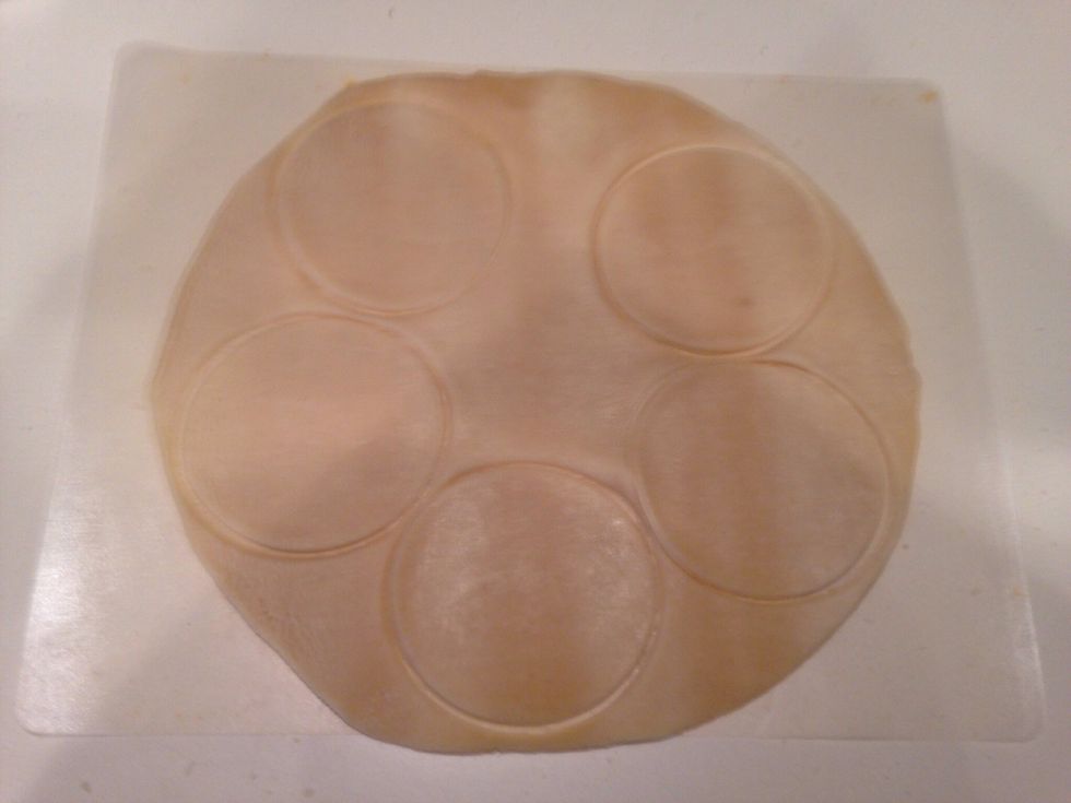 Let the crust sit on the counter for 15 minutes to get to room temp. Then lay out flat on cutting board. Use a cookie/biscuit/glass to cut out 3 inch circles like above.