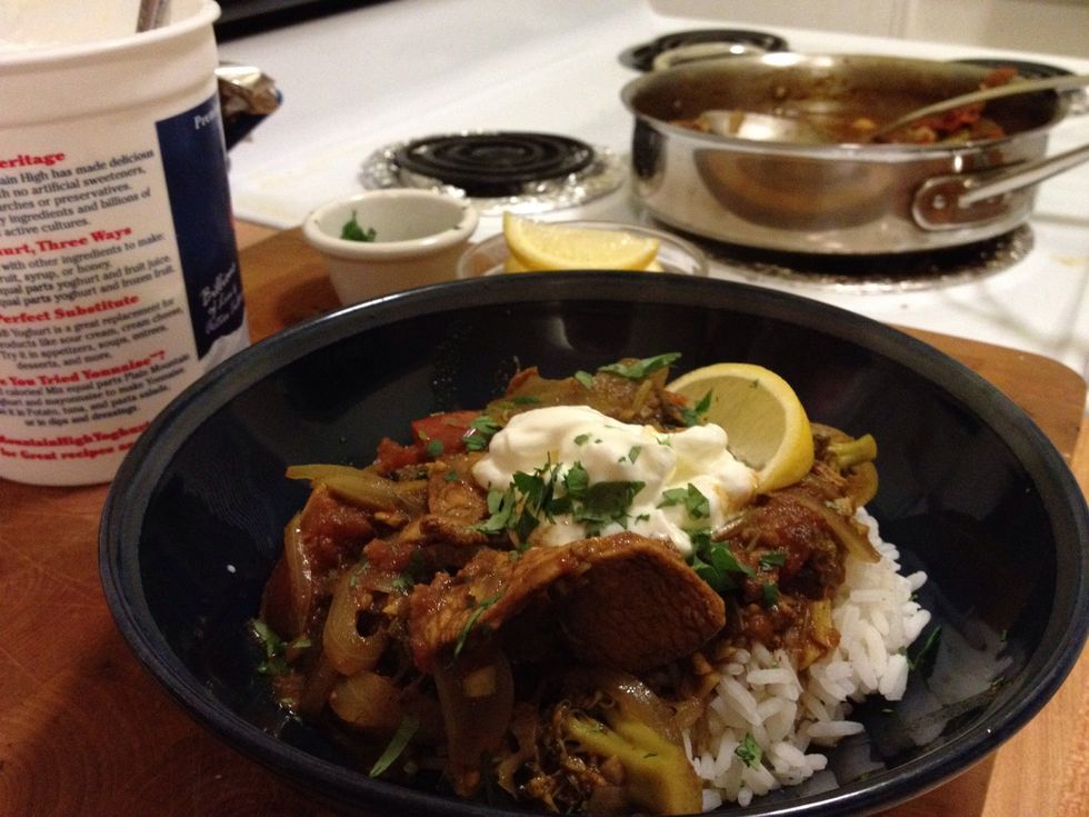 Let the curry rest off the heat so it can thicken a little bit. Pour it over some rice, top with dollop of natural yogurt, pinch of cilantro and maybe some almond or some red pepper flakes.
