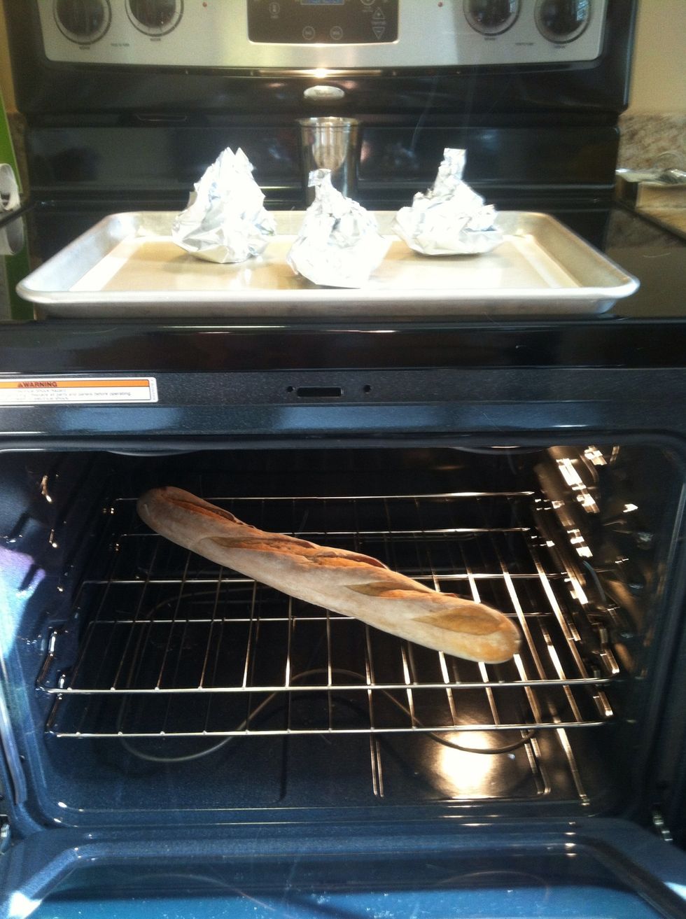 let the garlic cool for 5-10 minutes, this is the perfect time to warm up your bread