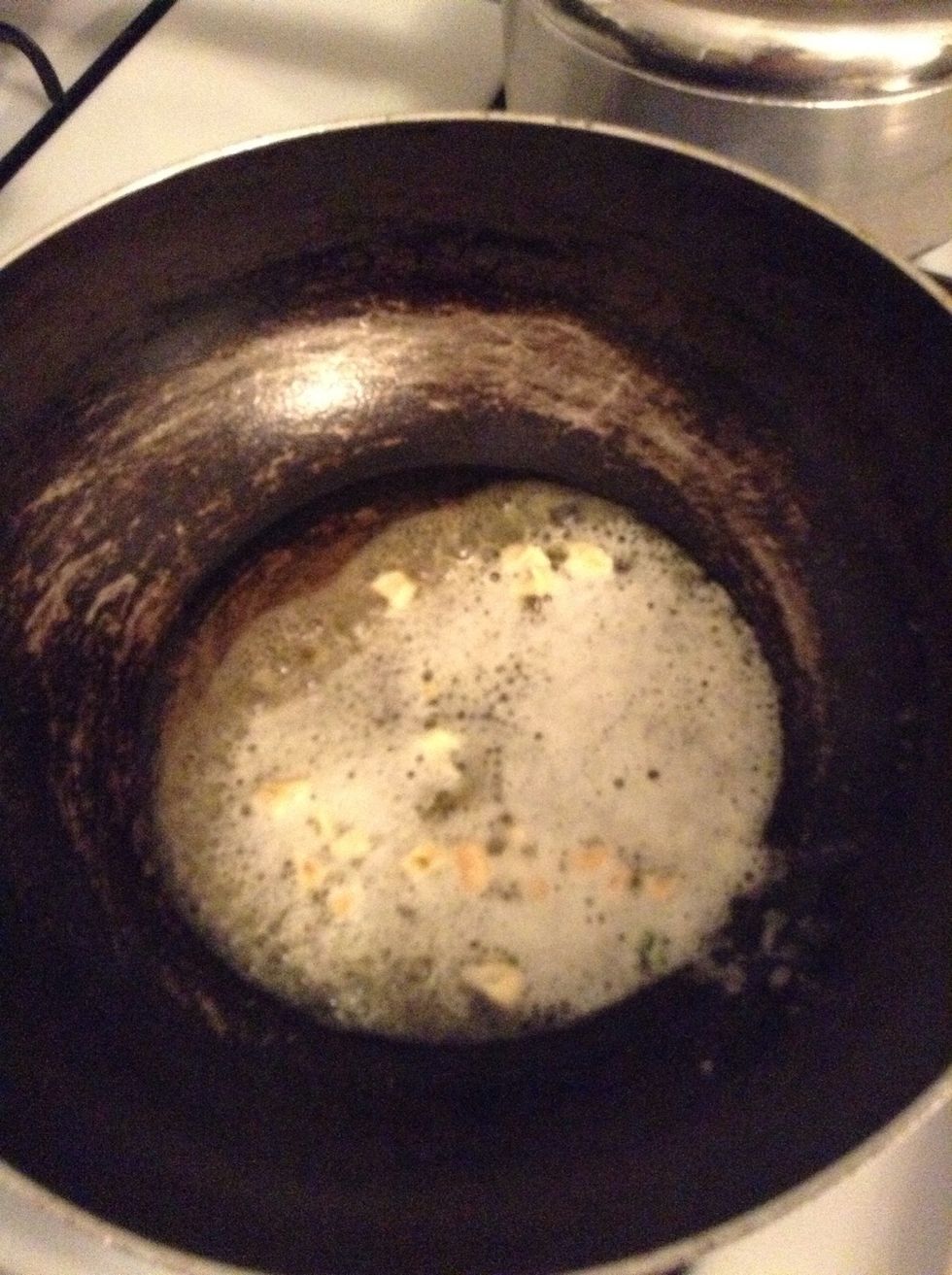 Let the garlic saut\u00e9 in the butter for about a minute