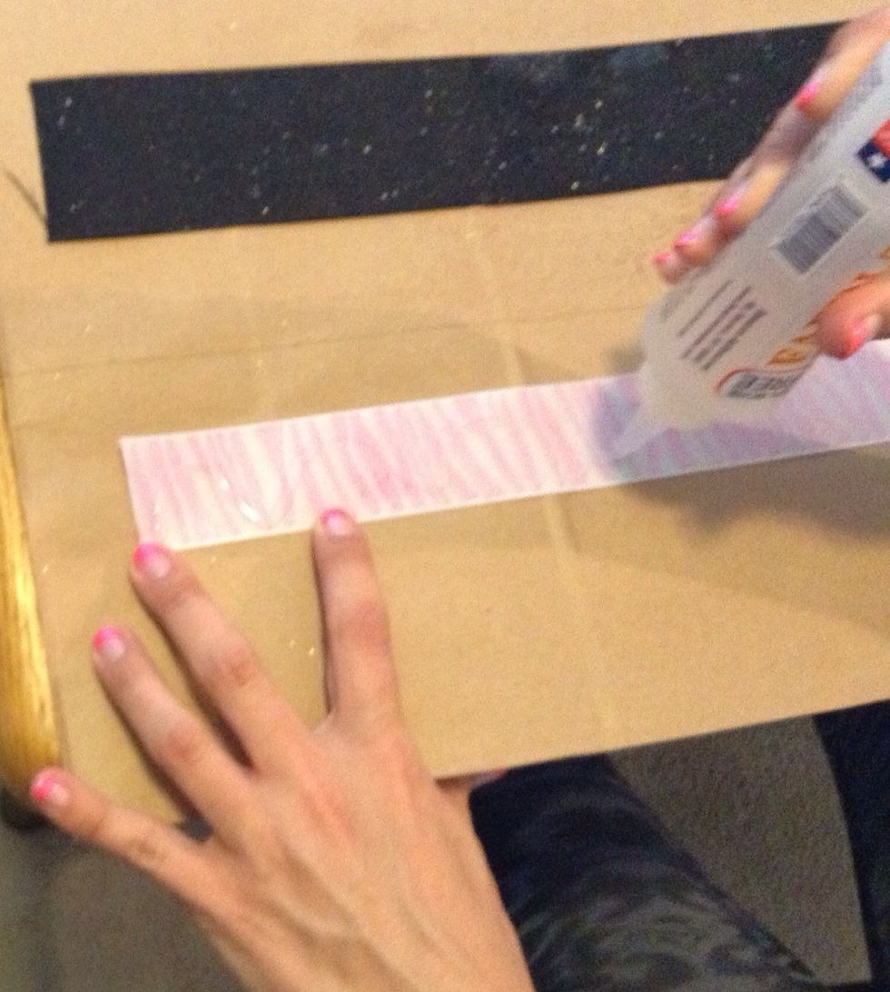 Let the glitter dry and apply the fabric tac glue to the backside of the smaller ribbon.