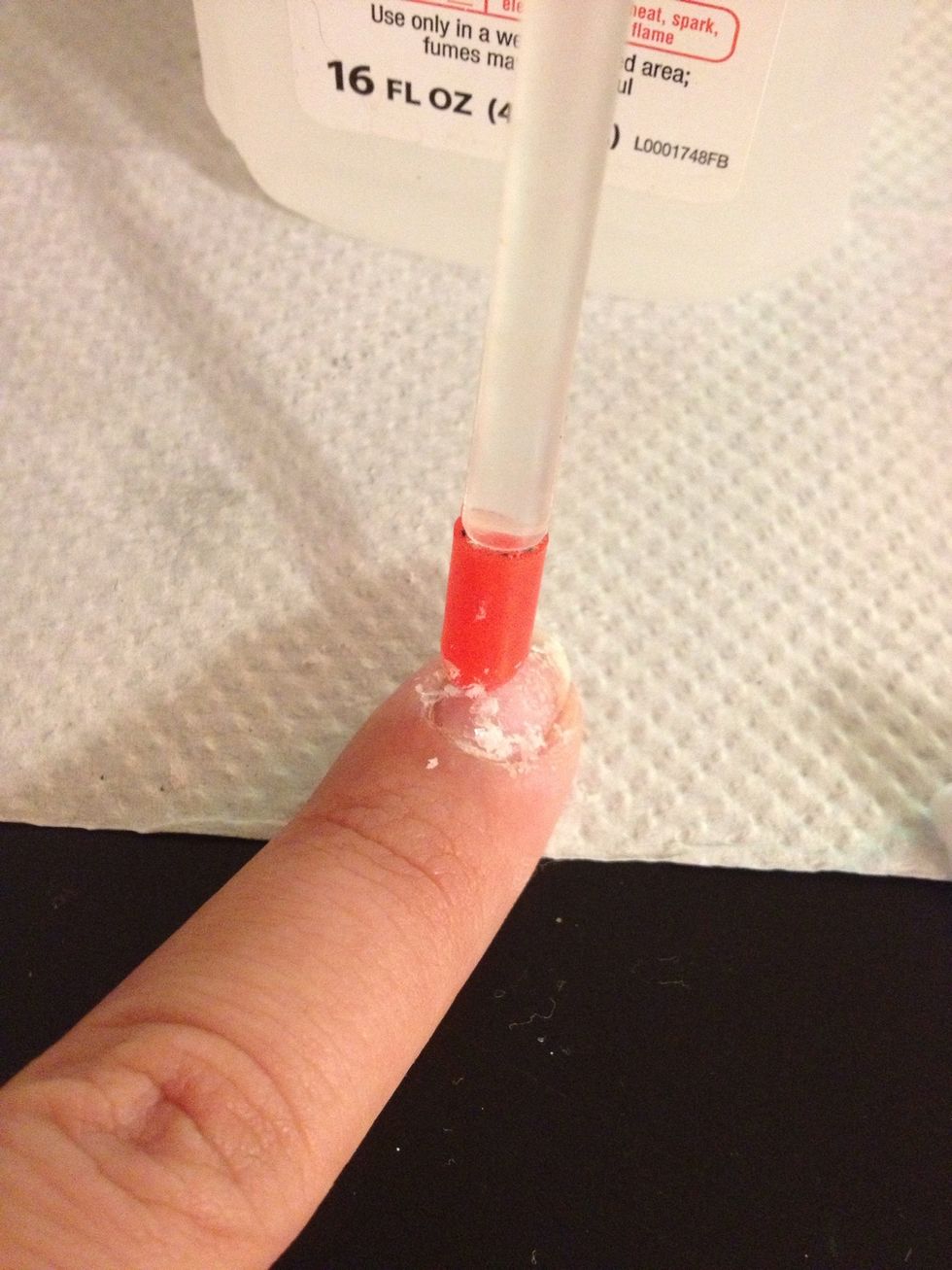 Let the nails soak in the acetone balls then scrape off the remaining polish with a cuticle pusher.