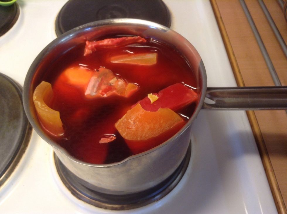 Let the water simmer until the candle wax has melted.