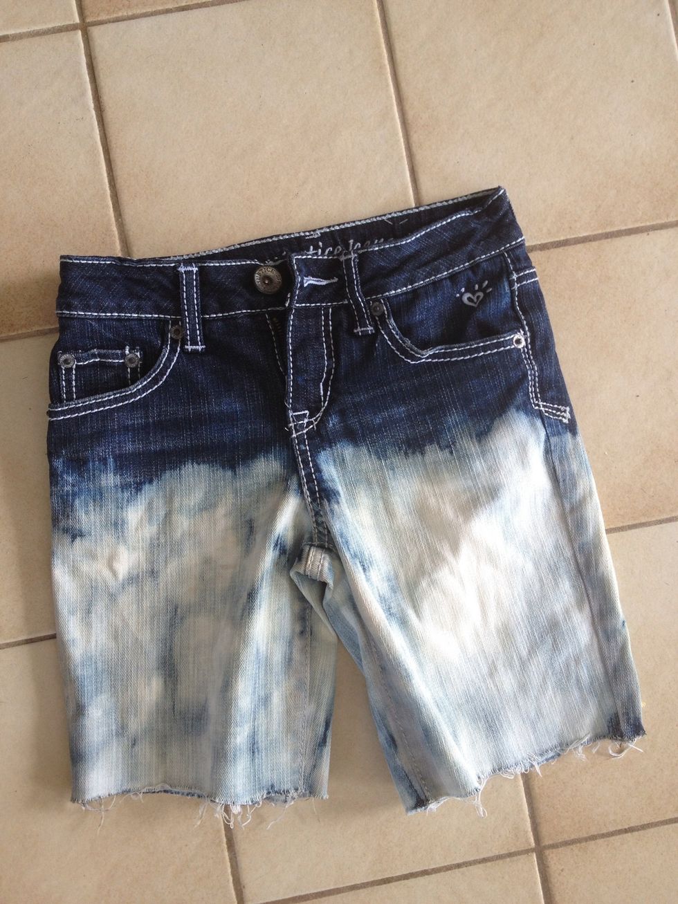 let them sit until they are the right "shade" for you then either rub soap on them (any kind) and then rinse them in a sink (or with a hose) OR put them through the washer and dryer