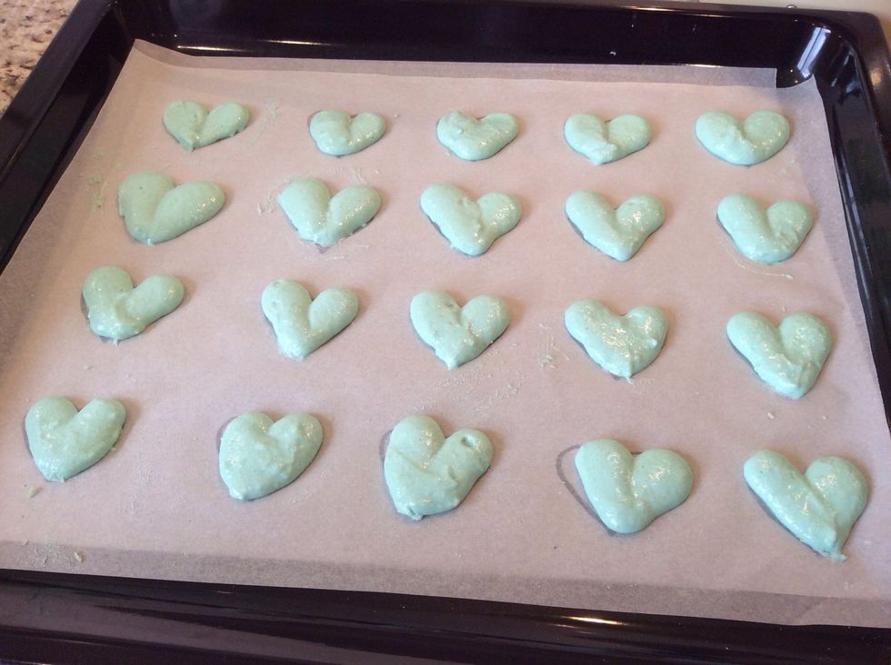 Let your macarons air dry for an hour so when you gently touch them they don't break or crack. Make sure you tap the tray on the bench to get rid of any air bubbles.
